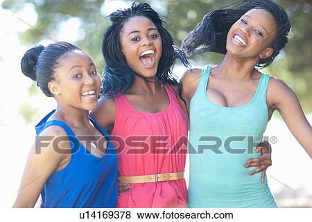 Smiling women hugging outdoors View Large Photo Image Stock Photo - Smiling women hugging outdoors. Fotosearch