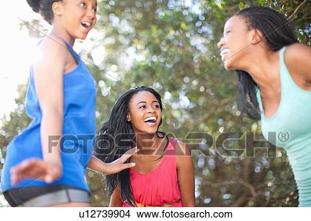 Smiling women playing outdoors View Large Photo Image Picture - Smiling women playing outdoors. Fotosearch