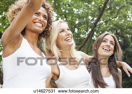 Smiling women standing together View Large Photo Image Stock Image - Smiling women standing together. Fotosearch