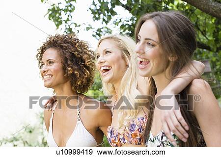 Smiling women standing together View Large Photo Image Stock Photo - Smiling women standing together. Fotosearch