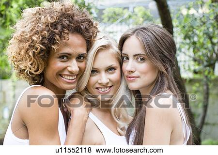 Stock Photo - Smiling women standing together. Fotosearch