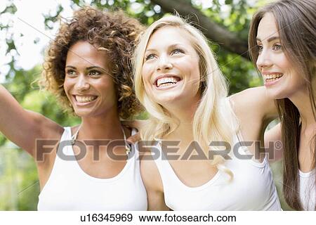 Smiling women standing together View Large Photo Image Stock Photo - Smiling women standing together. Fotosearch