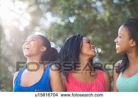 Picture - Smiling women walking outdoors. Fotosearch