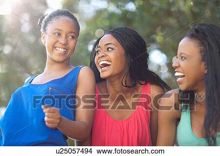 Smiling women walking outdoors View Large Photo Image Picture - Smiling women walking outdoors. Fotosearch