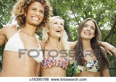 Smiling women wearing bikinis View Large Photo Image Stock Photo - Smiling women wearing bikinis. Fotosearch