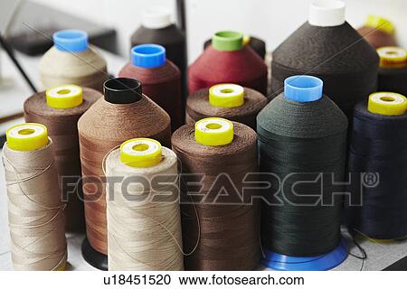 Stock Image - Spools of colored thread. Fotosearch