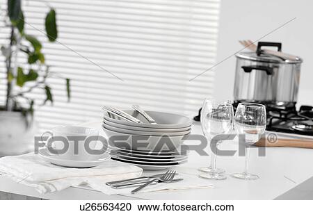 Stacked dishes and cutlery on table View Large Photo Image Stock Image - Stacked dishes and cutlery on table. Fotosearch