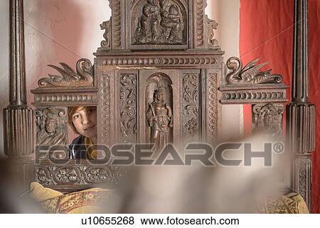 Stock Photo - Student examining medieval carving. Fotosearch