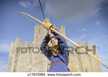 Student in period dress shooting arrow View Large Photo Image Picture - Student in period dress shooting arrow. Fotosearch