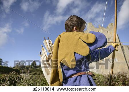 Student in period dress shooting arrow View Large Photo Image Picture - Student in period dress shooting arrow. Fotosearch