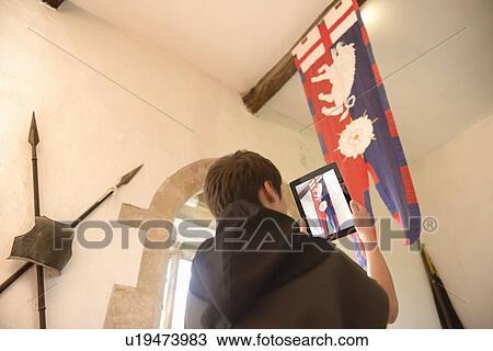 Stock Image - Student taking picture with computer. Fotosearch