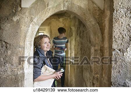 Stock Photo - Students examining medieval castle. Fotosearch
