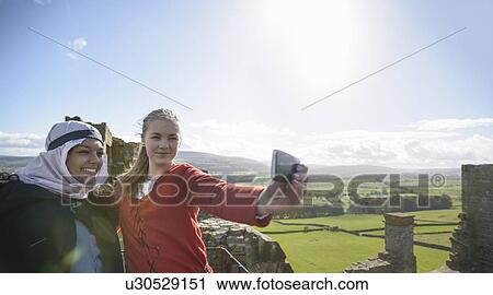 Stock Image - Students in period dress at castle. Fotosearch