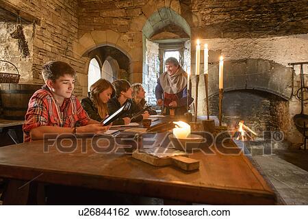 Stock Image - Students reading history in castle. Fotosearch