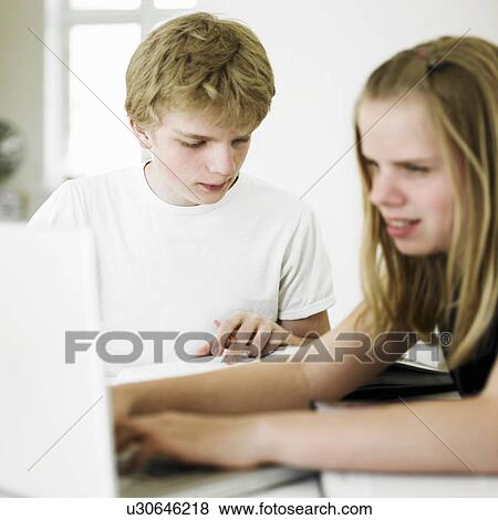 Students working together at table View Large Photo Image Stock Photo - Students working together at table. Fotosearch