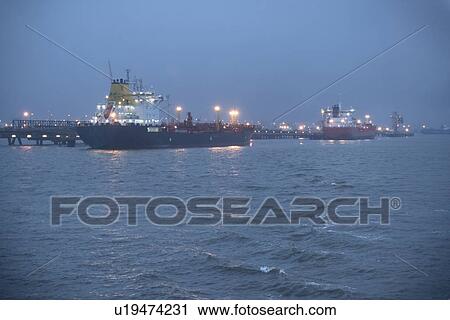 Tanker ships lit up at night View Large Photo Image Stock Image - Tanker ships lit up at night. Fotosearch