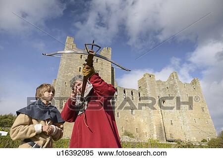 Teacher in period dress with crossbow View Large Photo Image Stock Photography - Teacher in period dress with crossbow. Fotosearch