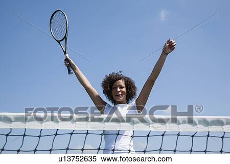 Tennis player cheering on court View Large Photo Image Stock Photography - Tennis player cheering on court. Fotosearch