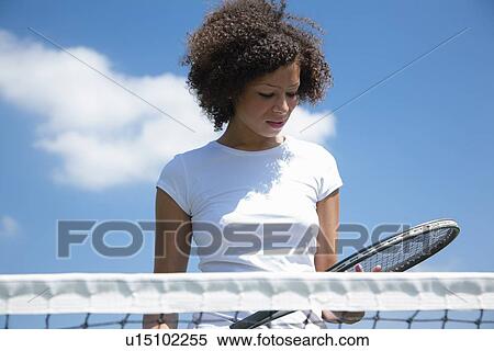 Tennis player with racket on court View Large Photo Image Stock Photography - Tennis player with racket on court. Fotosearch