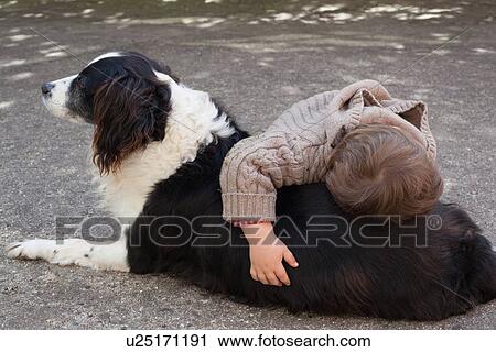 Toddler boy hugging dog outdoors View Large Photo Image Stock Image - Toddler boy hugging dog outdoors. Fotosearch