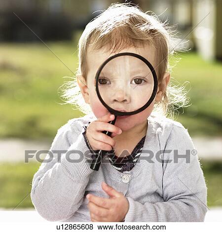 Toddler girl holding magnifying glass View Large Photo Image Stock Photo - Toddler girl holding magnifying glass. Fotosearch