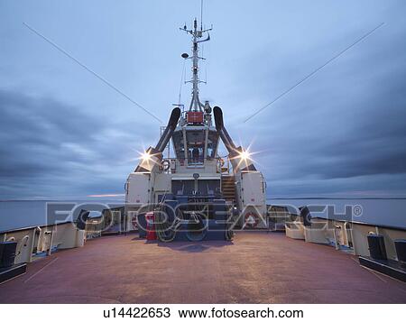 Tugboat deck lit up at night View Large Photo Image Stock Image - Tugboat deck lit up at night. Fotosearch