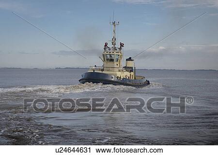 Tugboat sailing in water View Large Photo Image Stock Image - Tugboat sailing in water. Fotosearch