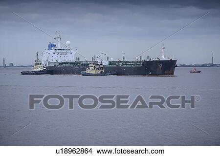 Tugboats pushing ship to harbor View Large Photo Image Picture - Tugboats pushing ship to harbor. Fotosearch