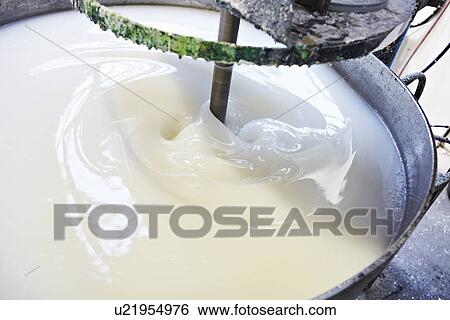 Stock Photograph - Vat of liquid being machine stirred. Fotosearch