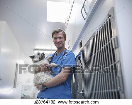 Veterinarian hugging dog in kennel View Large Photo Image Stock Image - Veterinarian hugging dog in kennel. Fotosearch