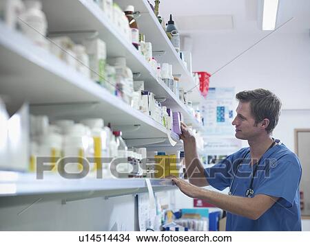 Picture - Veterinarian searching for medicine. Fotosearch