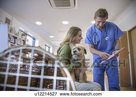 Stock Photo - Veterinarian talking to dog owner. Fotosearch