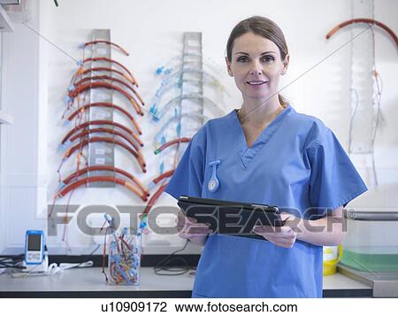 Veterinarian using tablet computer View Large Photo Image Stock Image - Veterinarian using tablet computer. Fotosearch