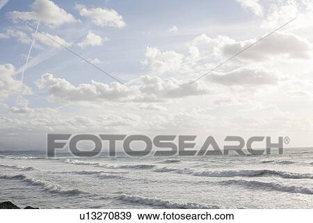 Stock Photo - Waves rolling in on beach. Fotosearch