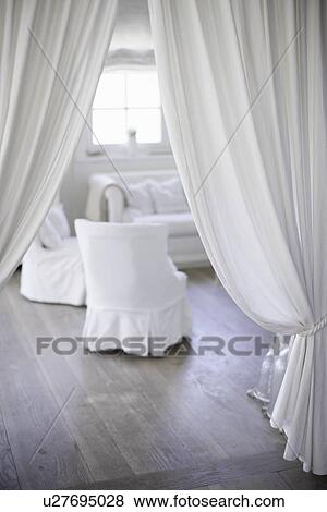 Stock Photo - White curtains and armchairs. Fotosearch