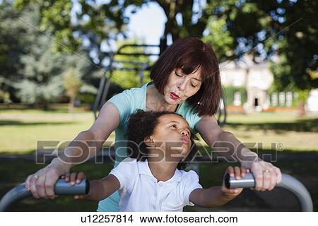 Picture - Woman and granddaughter playing in park. Fotosearch