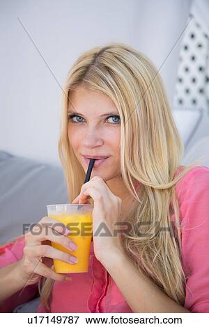 Woman drinking orange juice View Large Photo Image Stock Photo - Woman drinking orange juice. Fotosearch