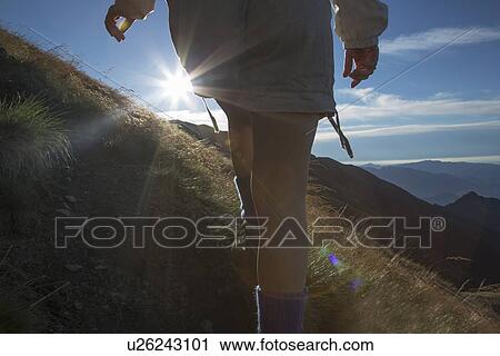 Woman hiking on rural hillside View Large Photo Image Stock Image - Woman hiking on rural hillside. Fotosearch