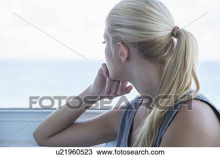Woman looking out window View Large Photo Image Stock Image - Woman looking out window. Fotosearch