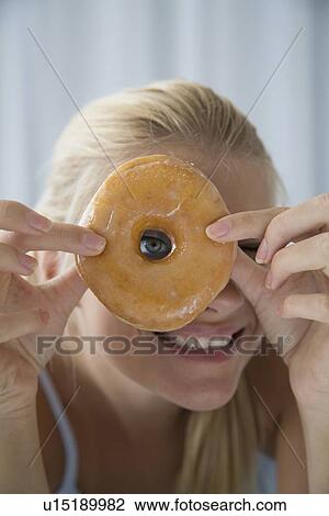 Woman peering through donut hole View Large Photo Image Stock Image - Woman peering through donut hole. Fotosearch