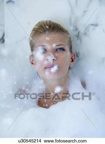 Picture - Woman playing in bubble bath. Fotosearch