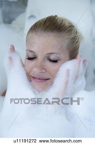 Woman playing in bubble bath View Large Photo Image Stock Image - Woman playing in bubble bath. Fotosearch