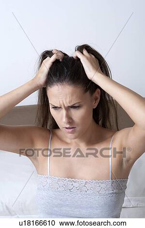 Woman scratching her head in bed View Large Photo Image Stock Image - Woman scratching her head in bed. Fotosearch