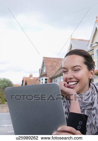 Woman using tablet computer outdoors View Large Photo Image Stock Image - Woman using tablet computer outdoors. Fotosearch