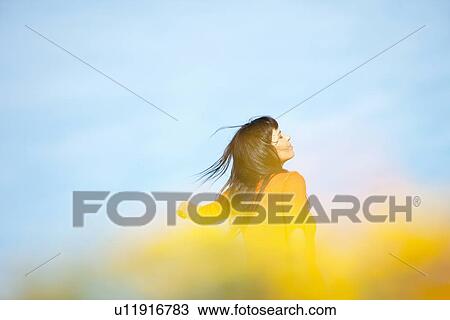 Stock Image - Woman walking outdoors. Fotosearch