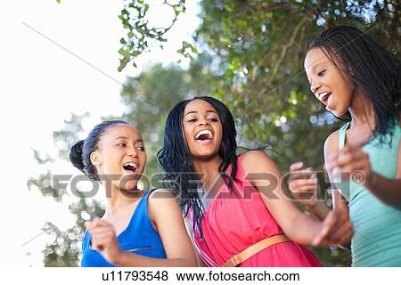 Stock Photo - Women dancing together outdoors. Fotosearch