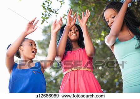 Stock Photo - Women dancing together outdoors. Fotosearch