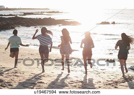 Women running together on beach View Large Photo Image Picture - Women running together on beach. Fotosearch