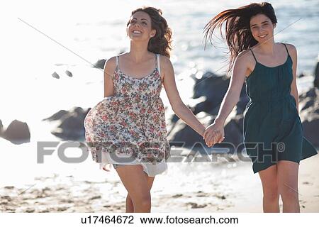 Women running together on beach View Large Photo Image Stock Image - Women running together on beach. Fotosearch