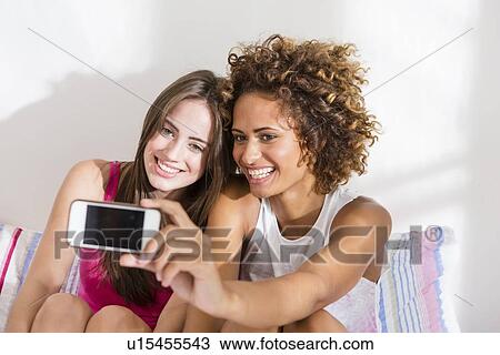 Women taking picture with cell phone View Large Photo Image Stock Image - Women taking picture with cell phone. Fotosearch
